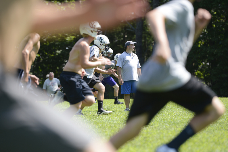 Chris Pingitore, Yarmouth High’s new head football coach, watches the kickoff teams run a drill on the first day of practice. Yarmouth, the two-time defending Class C state champion, begins its regular season Sept. 1 at Oak Hill.