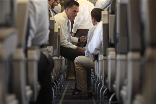 Republican presidential candidate, former Massachusetts Gov. Mitt Romney speaks to traveling press secretary Rick Gorka on the campaign charter flight before departure from Port Columbus International airport, Wednesday, Aug. 15, 2012, in Columbus , Ohio. (AP Photo/Mary Altaffer)