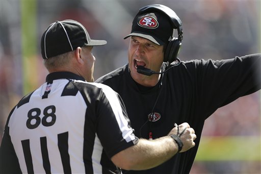 San Francisco 49ers head coach Jim Harbaugh, right, argues with an official during the second quarter of an NFL preseason football game against the Denver Broncos in Denver on Sunday.