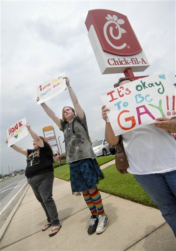 Gay marriage supporters, from left, Emmie Hesley, Cathy Dear and Amy Paffenroth hold signs in front of a Chick-fil-A in Fort Walton Beach, Fla. Thursday Aug. 2, 2012, in protest of the chicken eatery's stance on gay marriage. (AP Photo/Northwest Florida Daily News, Nick Tomecek)