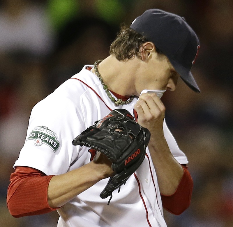 Boston Red Sox starting pitcher Clay Buchholz reacts after giving up a solo home run to Los Angeles Angels' Howard Kendrick during the sixth inning of a baseball game at Fenway Park in Boston on Wednesday, Aug. 22, 2012. (AP Photo/Elise Amendola)