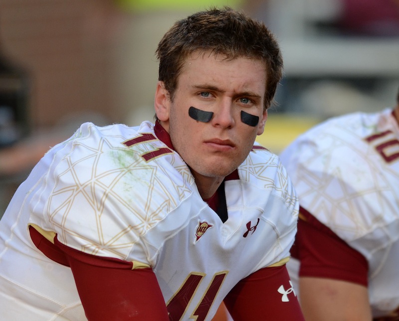 This Oct. 8, 2011 filoe photo shows Boston College quarterback Chase Rettig (11) watching from the bench the closing minutes of an NCAA college football game against Clemson. Rettig has seen Boston College plummet from an ACC contender to a team that posted the school's first losing record since 1998. Now it's his job to get the Eagles back to winning. (AP Photo/ Richard Shiro, File)