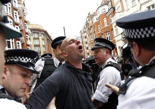 British police arrest protesters in support of WikiLeaks founder Julian Assange from the front of the Ecuadorian Embassy in central London today.