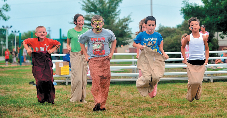 Children join in a sack race at the Family Fun Day hosted by Catholic Charities’ Children’s Case Management at North Street Park in Waterville on Saturday.