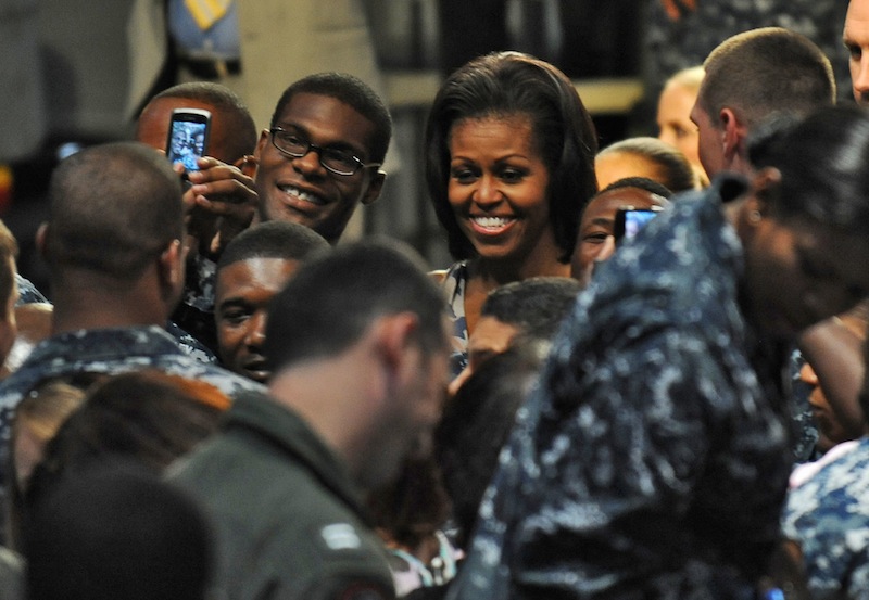 First Lady Michelle Obama greets sailors and their family members at the Mayport Naval Station in Jacksonville, Fla., Wednesday, Aug. 22, 2012. The first lady chose a naval station in the electoral battleground of Florida to announce that 2,000 businesses around the country have hired or trained more than 125,000 military veterans and spouses in the past year, exceeding a White House goal of 100,000 by the end of next year. (AP Photo/The Florida Times-Union, Bob Mack)