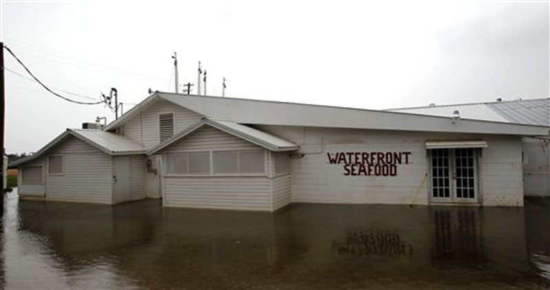 The Waterfront Seafood company is flooded as water covers Shell Belt Road in Bayou La Batre, Ala. on Tuesday, Aug. 28, 2012. The U.S. National Hurricane Center in Miami said Isaac became a Category 1 hurricane Tuesday with winds of 75 mph. It could get stronger by the time it's expected to reach the swampy coast of southeast Louisiana. (AP Photo/Butch Dill)