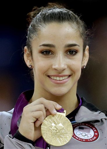 U.S. gymnast Aly Raisman displays her gold medal for the artistic gymnastics women's floor exercise final at the 2012 Summer Olympics in this Aug. 7, 2012, photo. 2012 London Olympic Games Summer Olympic games Olympic games Sports Events XXX Olympiad