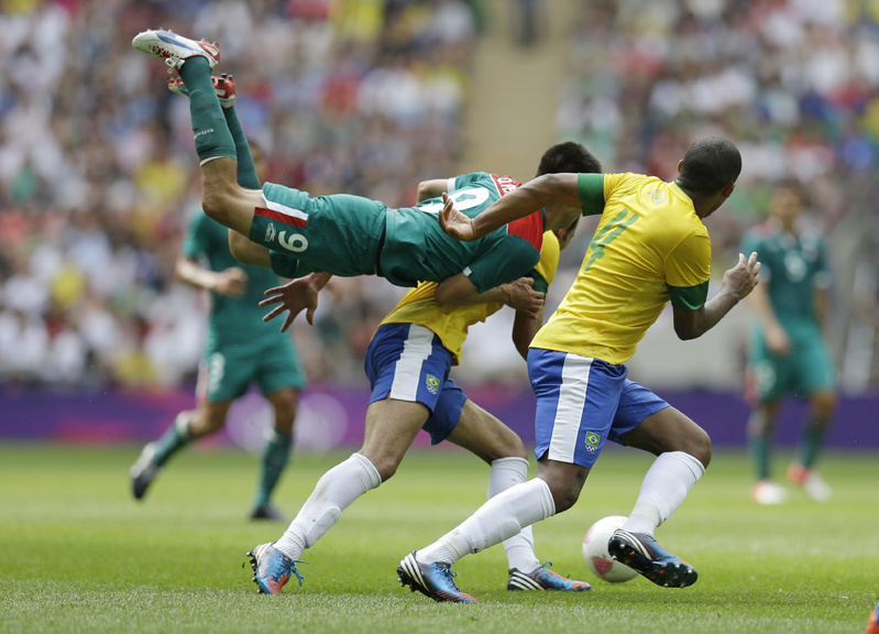 Mexico's Oribe Peralta goes airborne in front of Brazil's Juan Jesus, right, as they pursue the ball during the men's soccer final at the 2012 Summer Olympics on Saturday. 2012 London Olympic Games Summer Olympic games Olympic games Sports Events XXX Olympiad