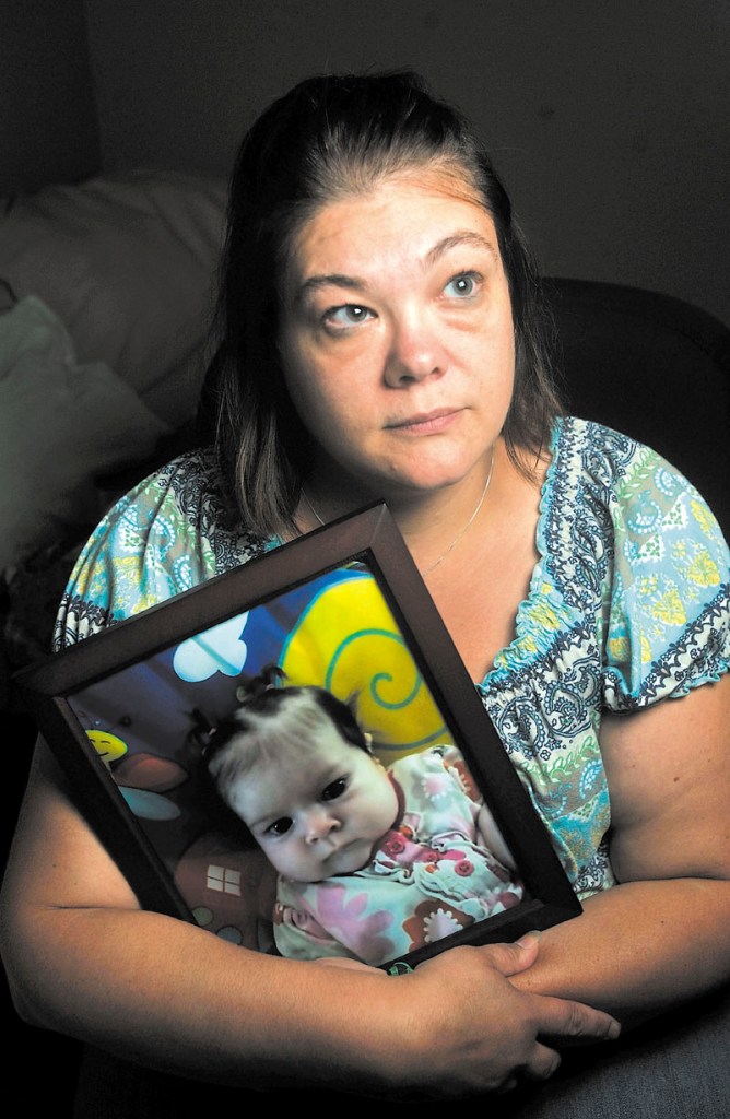 Nicole Greenaway holds a picture of her daughter, Brooklyn Foss-Greenaway, at her home in Clinton. Her 3-month-old baby died while in the care of a friend July 8.