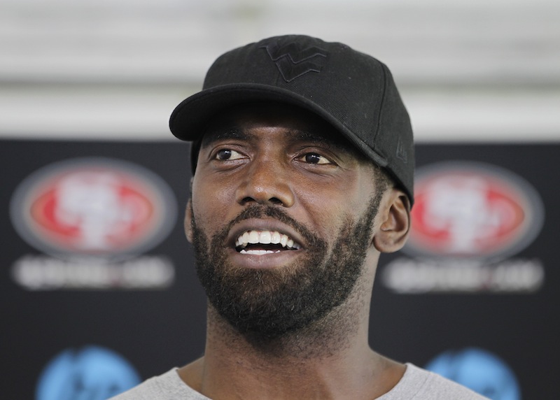 In this July 27, 2012 file photo, San Francisco 49ers wide receiver Randy Moss smiles during a news conference at the team's NFL football headquarters in Santa Clara, Calif. Both Moss and Seattle Seahawks' Terrell Owens are both determined to return to their dominating deep threats they were in their primes. (AP Photo/Paul Sakuma, file)