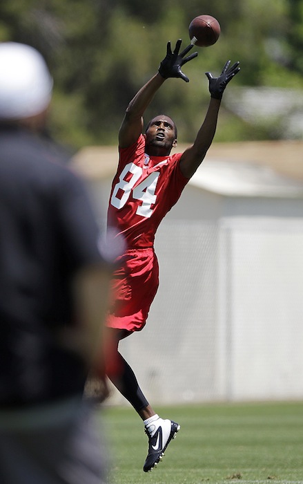In this May 10, 2012 file photo, San Francisco 49ers wide receiver Randy Moss catches a ball during NFL football practice at the team's training facility in Santa Clara, Calif. Both Moss and Seattle Seahawks' Terrell Owens are both determined to return to their dominating deep threats they were in their primes. (AP Photo/Paul Sakuma, file)