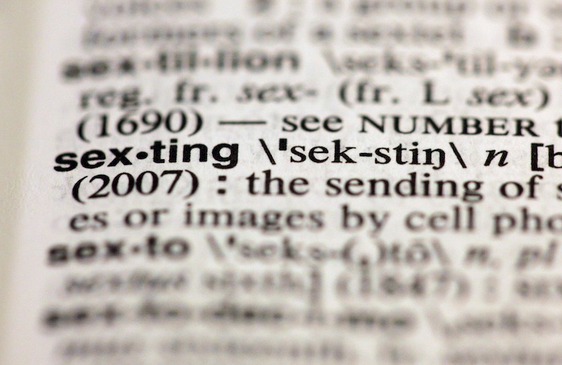 The entry "sexting," photographed in New York, Friday, Aug. 10, 2012, is one of the 15 new additions in the 11th edition of Merriam-Webster's Collegiate Dictionary. (AP Photo/Richard Drew)