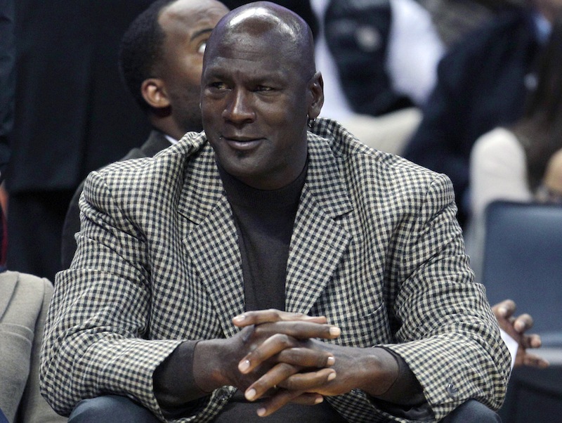 In this Jan. 14, 2012 file photo, Charlotte Bobcats basketball team owner Michael Jordan watches during the first half of an NBA basketball game between the Charlotte Bobcats and the Golden State Warriors in Charlotte, N.C. Tuesday, Aug. 7, 2012. President Barack Obama is joining with NBA legend Michael Jordan and an array of basketball stars to raise money for his re-election campaign later this month. The Obama campaign is planning a fundraising "shoot-around" and dinner in New York on Aug. 22 featuring several NBA stars. (AP Photo/Chuck Burton)
