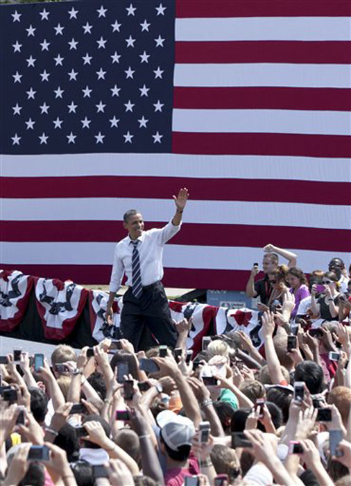 President Barack Obama arrives to a campaign stop in Ames, Iowa, Tuesday, Aug. 28, 2012. The president's event in Ames, home of Iowa State University, is part of a tour through college towns. (AP Photo/Nati Harnik)