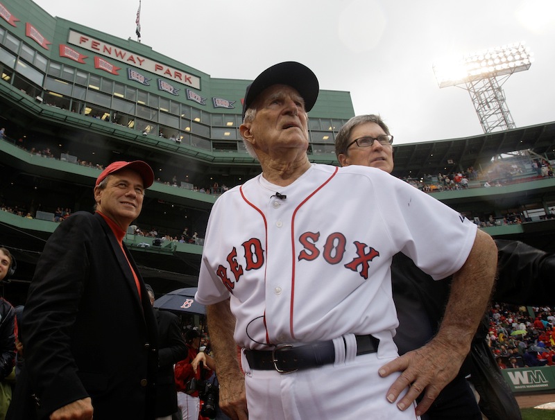 In this Sept. 28, 2008, file photo, Boston Red Sox great Johnny Pesky, center, is flanked by team president Larry Lucchino, left, and owner John Henry as they look past Pesky's Pole where Pesky's No. 6 adorns the upper deck during a ceremony to retire his number prior to a baseball game against the New York Yankees at Fenway Park in Boston. Pesky, who spent most of his 60-plus years in pro baseball with the Red Sox and was beloved by the team's fans, has died on Monday, Aug. 13, 2012, in Danvers, Mass. He was 92. (AP Photo/Charles Krupa, File)