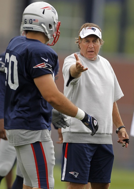 New England Patriots head coach Bill Belichick, right, speaks with Patriots defensive end Aaron Lavarias (60), left, during an NFL football training camp in Foxborough, Mass., Sunday, July 29, 2012. (AP Photo/Steven Senne)