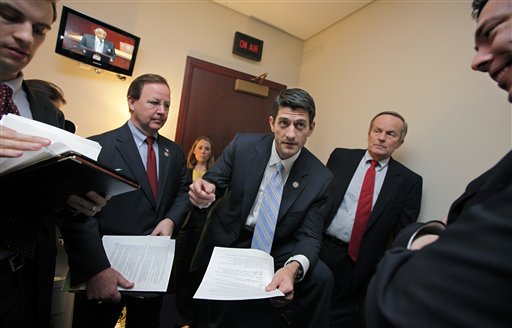 House Budget Committee Chairman Paul Ryan, R-Wis., works with Republican members of the committee on Capitol Hill in April before introducing his controversial "Path to Prosperity" debt-reduction plan. He is flanked by Rep. Todd Akin, R-Mo., right, with Rep. Bill Flores, R-Texas, at left.
