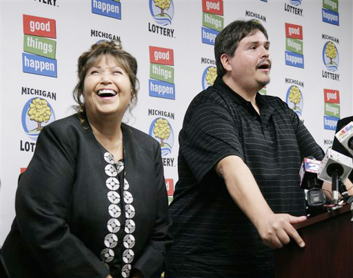Donald Lawson, a 44-year-old Lapeer, Mich. resident, appears at a news conference Friday in which he claimed the $337 million Powerball prize. His mother, left, did not want to be identified.