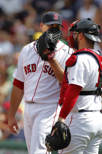 Boston Red Sox pitcherJosh Beckett, left, speaks with catcher Kelly Shoppach after Beckett gave up hits in the third inning of a baseball game against the Texas Rangers at Fenway Park in Boston, Wednesday, Aug. 8, 2012. The Rangers won 10-9. (AP Photo/Steven Senne)