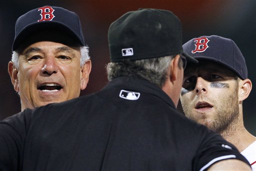 Boston Red Sox manager Bobby Valentine, left, and Boston's Dustin Pedroia, right, argue with first base umpire Paul Nauert in the ninth inning of a baseball game against the Texas Rangers in Boston on Tuesday. Pedroia was ejected. The Rangers won 6-3.