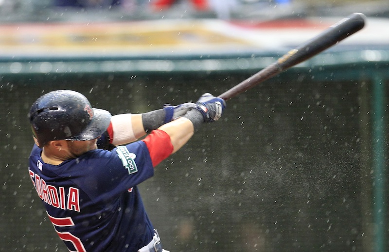 Boston Red Sox's Dustin Pedroia hits an RBI single off Cleveland Indians starting pitcher Chris Seddon in the fourth inning of a baseball game, Friday, Aug. 10, 2012, in Cleveland. Mike Aviles scored. (AP Photo/Tony Dejak)