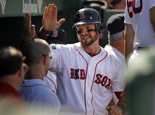 Boston Red Sox's Cody Ross, center, celebrates in the dugout after scoring on an RBI single Red Sox's James Loney in the sixth inning of a baseball game against the Kansas City Royals at Fenway Park, Monday, Aug. 27, 2012, in Boston. The Red Sox won 5-1. (AP Photo/Steven Senne)