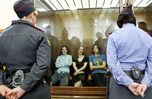Feminist punk group Pussy Riot members, from left, Yekaterina Samutsevich, Maria Alekhina and Nadezhda Tolokonnikova sit in a glass cage in a courtroom in Moscow today. The women, two of whom have young children, were found guilty of "hooliganism."