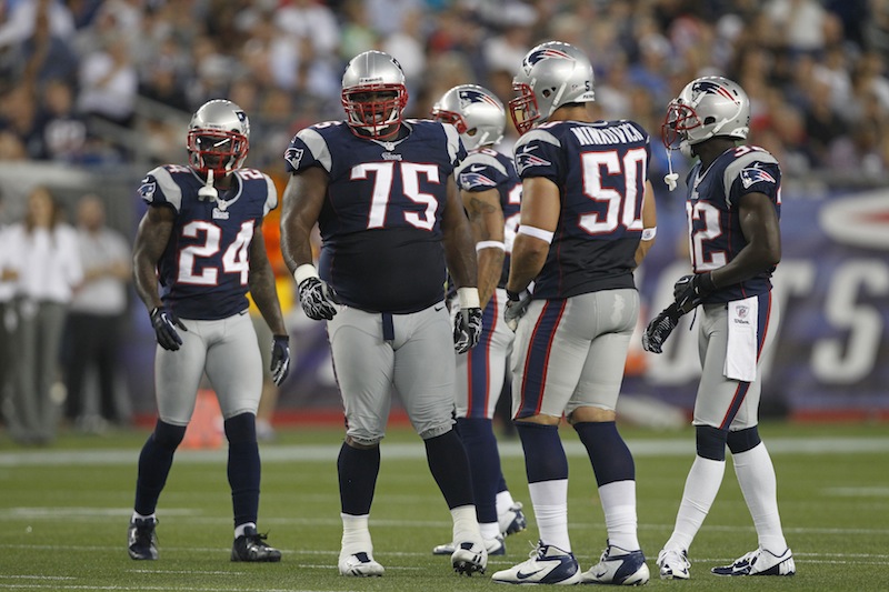 New England Patriots defensive back Kyle Arrington (24), nose tackle Vince Wilfork (75), linebacker Rob Ninkovich (50) and New England Patriots defensive back Devin McCourty (32) during a break in the action of their first NFL preseason football game against the New Orleans Saints in Foxborough, Mass., Thursday, Aug. 9, 2012. (AP Photo/Michael Dwyer)