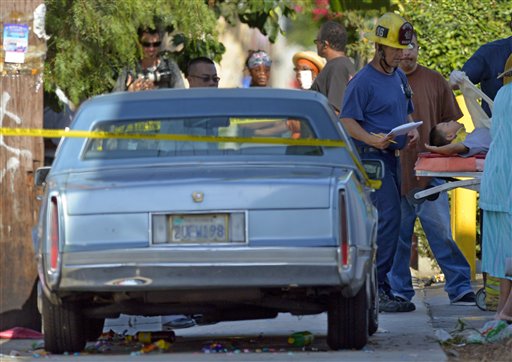 Los Angeles city firefighters attend to victims after a car driven by a 100-year-old went onto a sidewalk and plowed into a group of parents and children outside a South Los Angeles elementary school on Wednesday.