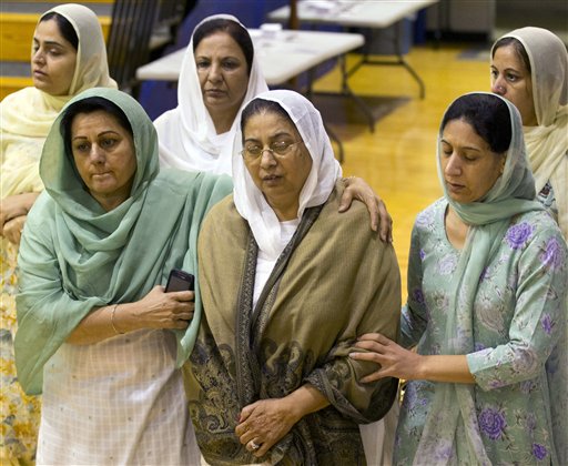 Mourners grieve at the funeral and memorial service for the six victims of the Sikh Temple of Wisconsin mass shooting in Oak Creek, Wis., today.