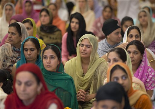 People attend a prayer service at the Sikh Temple of Wisconsin in Oak Creek, Wis., on Aug. 12, 2012, for the first Sunday prayer service since a white supremacist shot and killed six people there before fatally shooting himself.