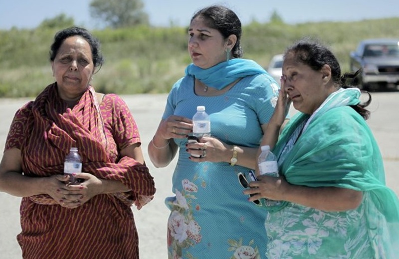 Women who said they family members were in the Sikh temple in Oak Creek, Wis., wait for information after a shooting there Sunday morning.