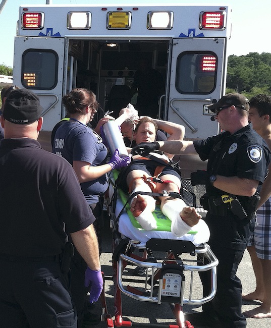 In this Monday, July 30, 2012 photo, Christopher Myers is loaded on an ambulance at Ballston Beach in Truro, Mass., after sustaining shark-bite wounds to his legs while swimming. (AP Photo/Cape Cod Times, Eric Williams)