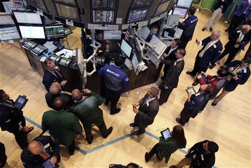 Traders and floor officials gather at a post on the floor of the New York Stock Exchange. U.S.-traded Chinese companies have faced scrutiny after auditors for several quit and others were accused of accounting irregularities. Concerns about company finances have cost investors several billion dollars.