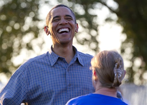 President Barack Obama laughs as he talks with people during a visit to the Iowa State Fair, Monday, Aug. 13, 2012, in Des Moines, Iowa. The president is on a three-day campaign bus tour through Iowa. (AP Photo/Carolyn Kaster)