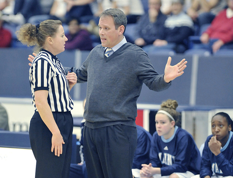 Richard Barron, the University of Maine women’s basketball coach, asks for a referee’s help in deciphering a call in a game late last year in Orono. Going to Europe to recruit “was out of necessity more than anything,” the coach said.