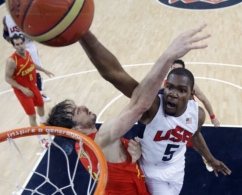 United States' Kevin Durant (5) slam dunks to score over Spain's Pau Gasol, left, during the men's gold medal basketball game at the 2012 Summer Olympics on Sunday.