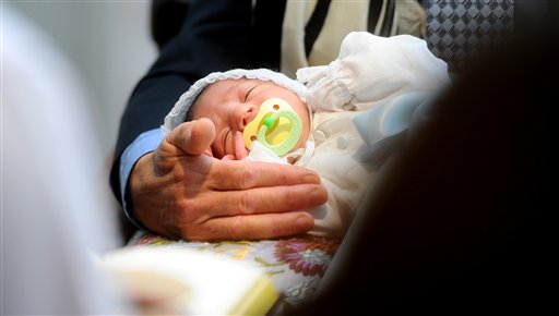 In a 2011 file photo, Benjamin Abecassis closes his eyes during his bris, a Jewish circumcision ceremony, in San Francisco. The American Academy of Pediatrics, which represents pediatricians across the Unted States, has released a policy statement that says the health benefits of male circumcision far outweigh any risks it might offer.