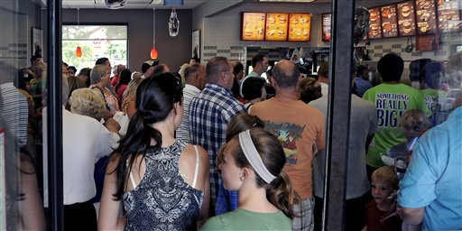 Customers wait on line at a packed Chick-fil-A in Myrtle Beach, S.C. during lunch, Wednesday, Aug. 1, 2012. Supporters of Chick-fil-A are planning to eat at restaurants in the chicken chain as the company continues to be criticized for an executive's comments about gay marriage. Former Arkansas Gov. Mike Huckabee, a Baptist minister, declared Wednesday national "Chick-fil-A Appreciation Day." Opponents of the company's stance are planning "Kiss Mor Chiks" for Friday, when they are encouraging people of the same sex to show up at Chick-fil-A restaurants around the country and kiss each other. (AP Photo/The Sun News, Charles Slate) (REV-SHARE) Chick-fil-A Appreciation Day