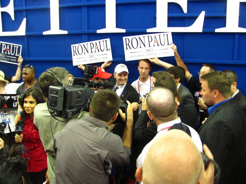 Bernie Johnson, a Maine delegate from Lamoine wearing a white "Ron Paul Maine 2012" baseball hat, stands in the middle of an impromptu press conference that took place on the floor of the Republican National Convention on Monday after official business was over. Supporters of Paul from several states have been pushing for Republican officials to recognize the Texas congressman and seat more of his delegates to the convention.