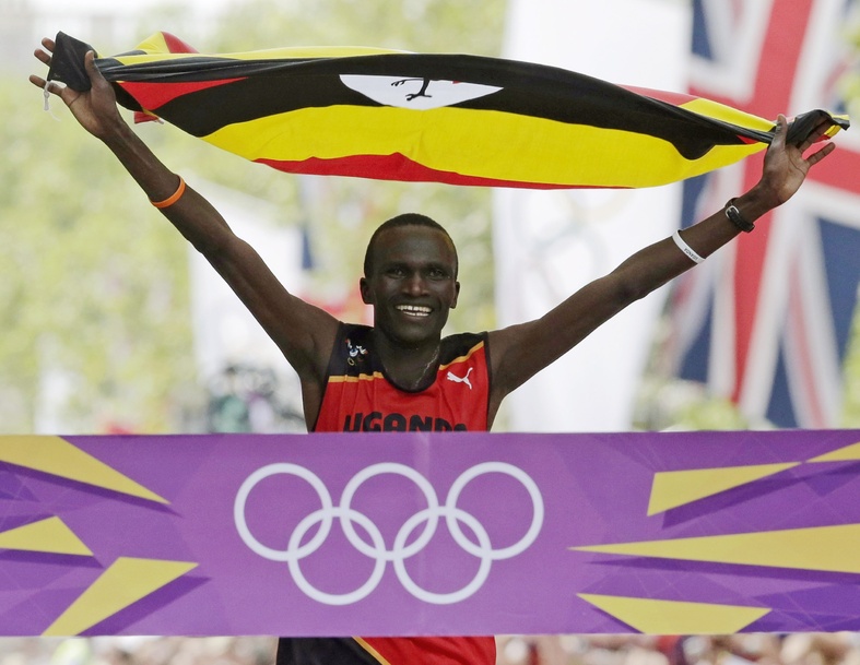 Stephen Kiprotich of Uganda celebrates as he crosses the finish line to win the men's marathon at the 2012 Summer Olympics in London Sunday.