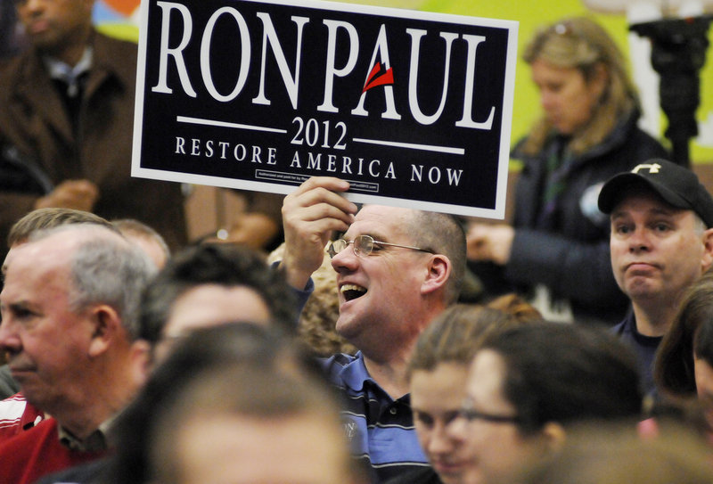 Glenn Strout of Portland holds a sign in support of Texas Rep. Ron Paul during the Portland Republican City Committee Caucus in February. The fate of Maine’s delegation to the Republican National Convention remained murky on Tuesday as delegates loyal to Ron Paul continued to negotiate with national party leaders intent on presenting a unified front for Mitt Romney at next week’s mega-event.