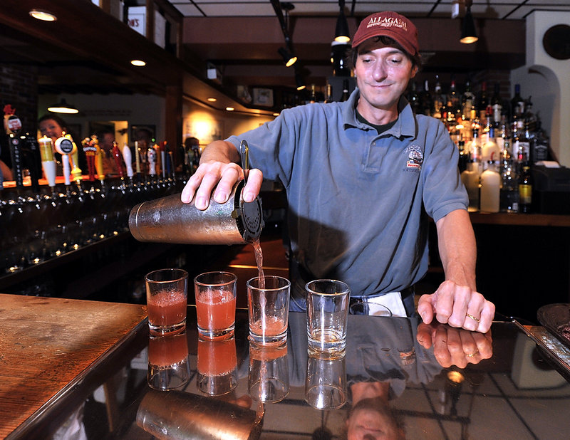 Bartender Billy Rice makes his famous “Pink Drinks” at Three Dollar Deweys, a landmark in Portland’s Old Port. Rice uses vodka, triple sec, fresh squeezed lime and cranberry juice in the concoction. Beers and ciders also are offered, by the pint and bottle, from $3 to $6.