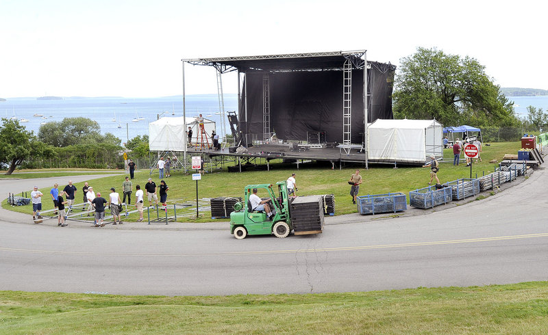 Workers set up the stage Wednesday for the Mumford & Sons concert on Saturday on the Eastern Prom in Portland.