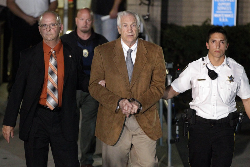 Former Penn State University assistant football coach Jerry Sandusky, center, leaves the Centre County Courthouse after his conviction on June 22. He plans to speak at his sentencing.