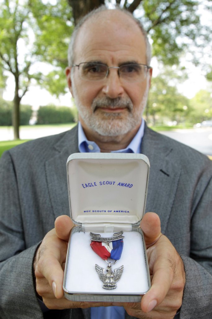 Dr. Robert Wise holds the Eagle Scout medal he is returning to protest the Scouts' policy on gays.