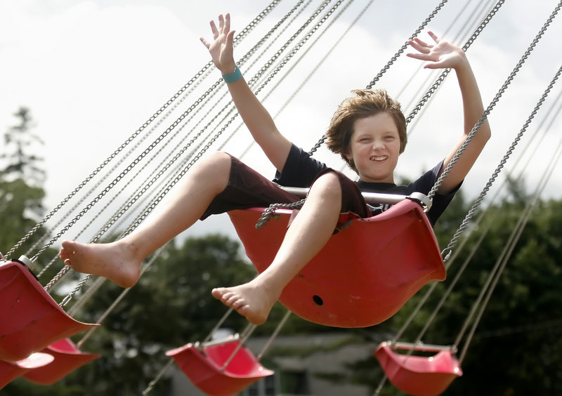 A youngster enjoys the swings at the Topsham Fair, which opens Thursday.