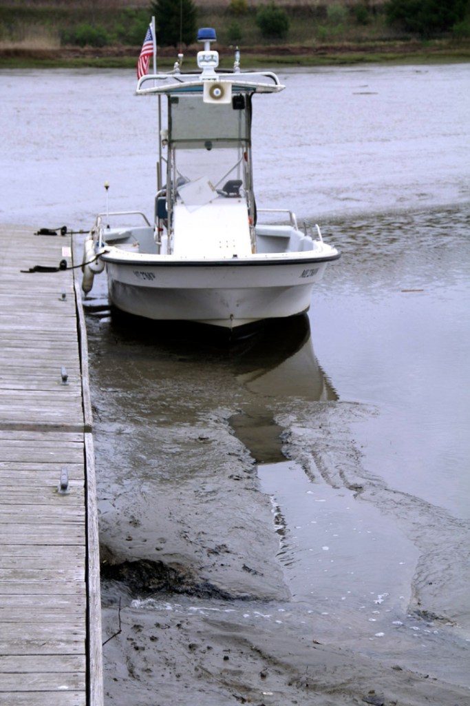 A boat rests on mud in the Royal River during a “super drainer” low tide in May. “Most of our moorings have less than 2 feet of water at low tide,” said Harbor Master Richard Imbeault.
