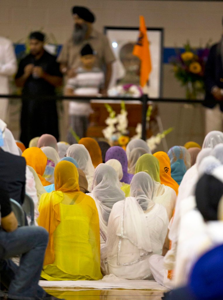 Mourners attend the memorial service for the six victims of the Sikh temple mass shooting in Oak Creek, Wis., Friday in the Oak Creek High School gymnasium. Three other people were wounded in the shooting last Sunday.