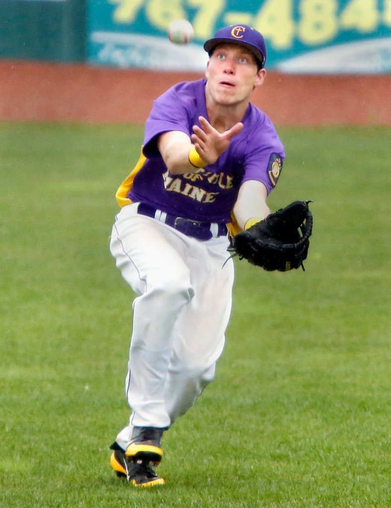 Right fielder Cam Mullen of First Title keeps his eyes on the ball while making a running catch in the rain against Saratoga, N.Y., in the seventh inning Friday. First Title won, 10-1.